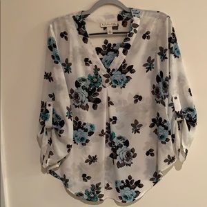 Floral blouse with cute detail on the sleeve.